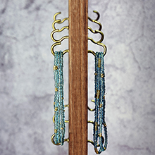metal gold hooks on rotating wooden display and organizer rack board